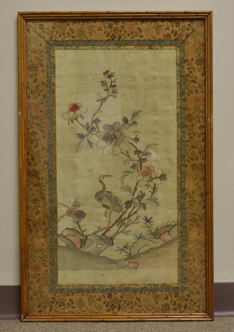 Chinese Framed Silk "Kesi"Embroidery w/ Crane: A large, antique, Chinese, silk embroidery of a crane standing beneath extraordinarily large peonies, matted with three bands of floral patterned embroidered silk in a wooden frame styled as 3-tiers o