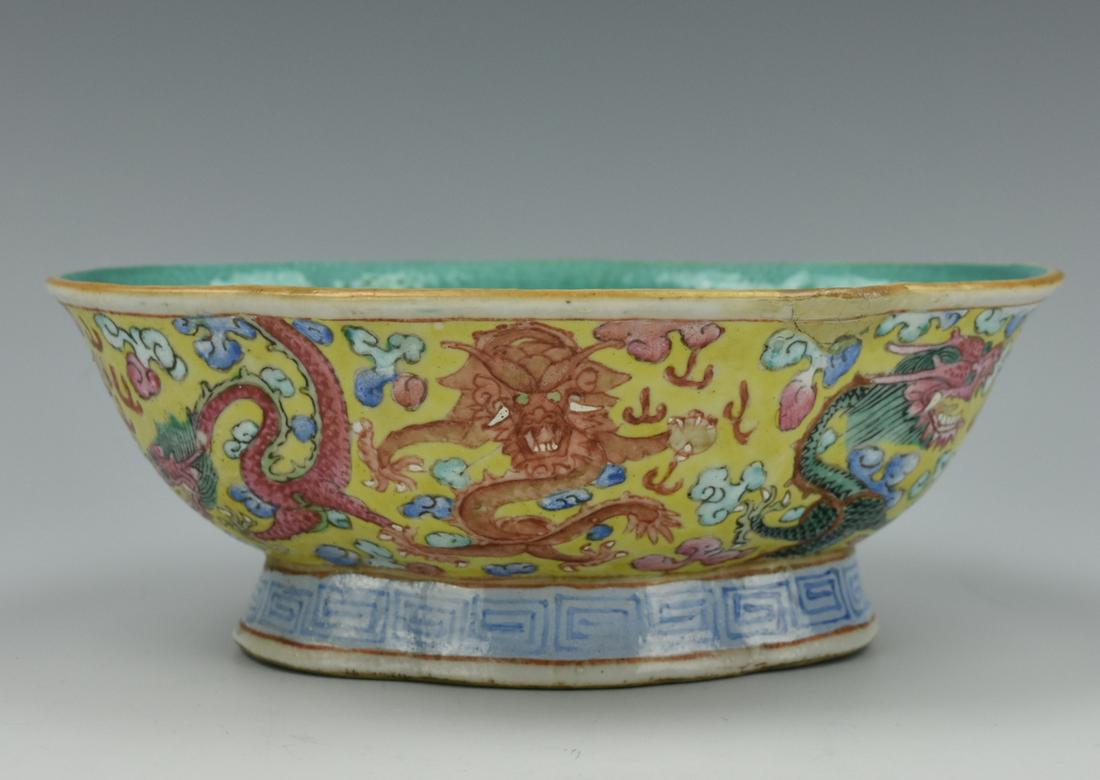 Chinese Famille Rose Quatrefoil Dragon Bowl,19th C: A Chinese, porcelain bowl of quatrefoil form on a raised foot, the interior with a mottled teal glaze, the exterior with colored dragons and flaming pearls upon a soft yellow ground, the underside wit