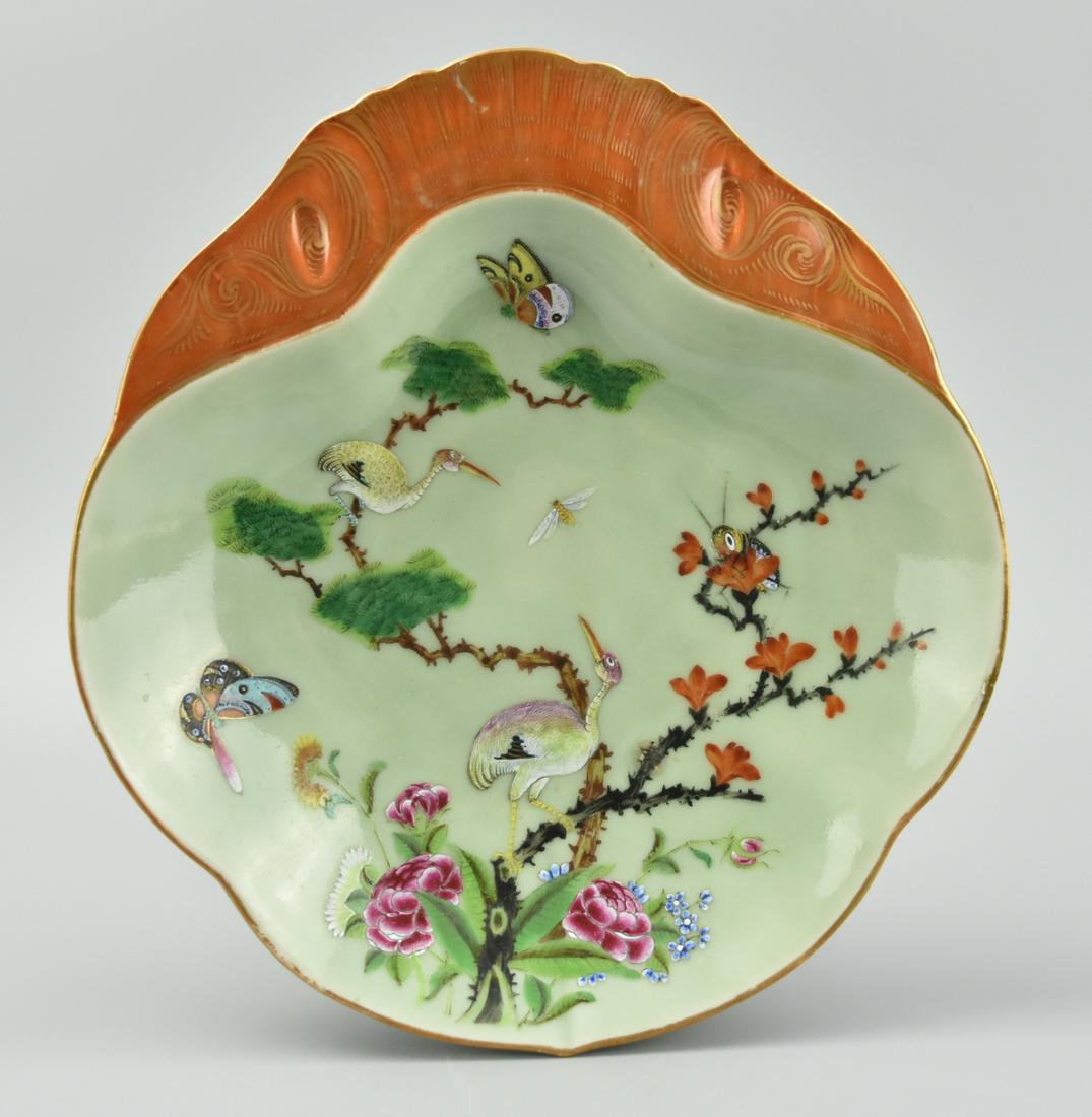 Chinese Lobed,Celadon & Famille Rose Plate,19th C.: A celadon glazed, Chinese, porcelain dish with four-lobed rim & body, a flattened lip at the top painted in copper red with gilded markings, cranes, crickets, & butterflies amid flowers within the wel