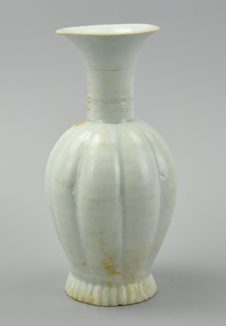 Chinese Hutian Ware Fluted Vase, Song Dynasty: This vase features a teal under-glaze and a white over glaze which is further colored shades of orange due to a chemical reaction that took place within the kiln. Itâ€™s foot is tall and fluted m