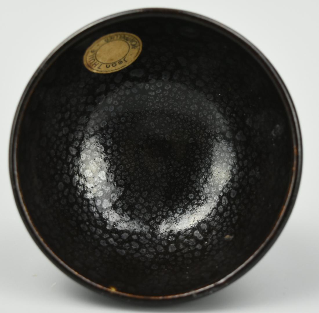 Chinese Jian Ware"Oil Spot" Tea Bowl, Song Dynasty: A Chinese/ Japanese earthenware tea bowl with Jian "oil spots" of carbon grey within the black-brown glaze. D: 3 1/2" (8.9cm) Condition: In excellent condition with a small chip to the bottom rim