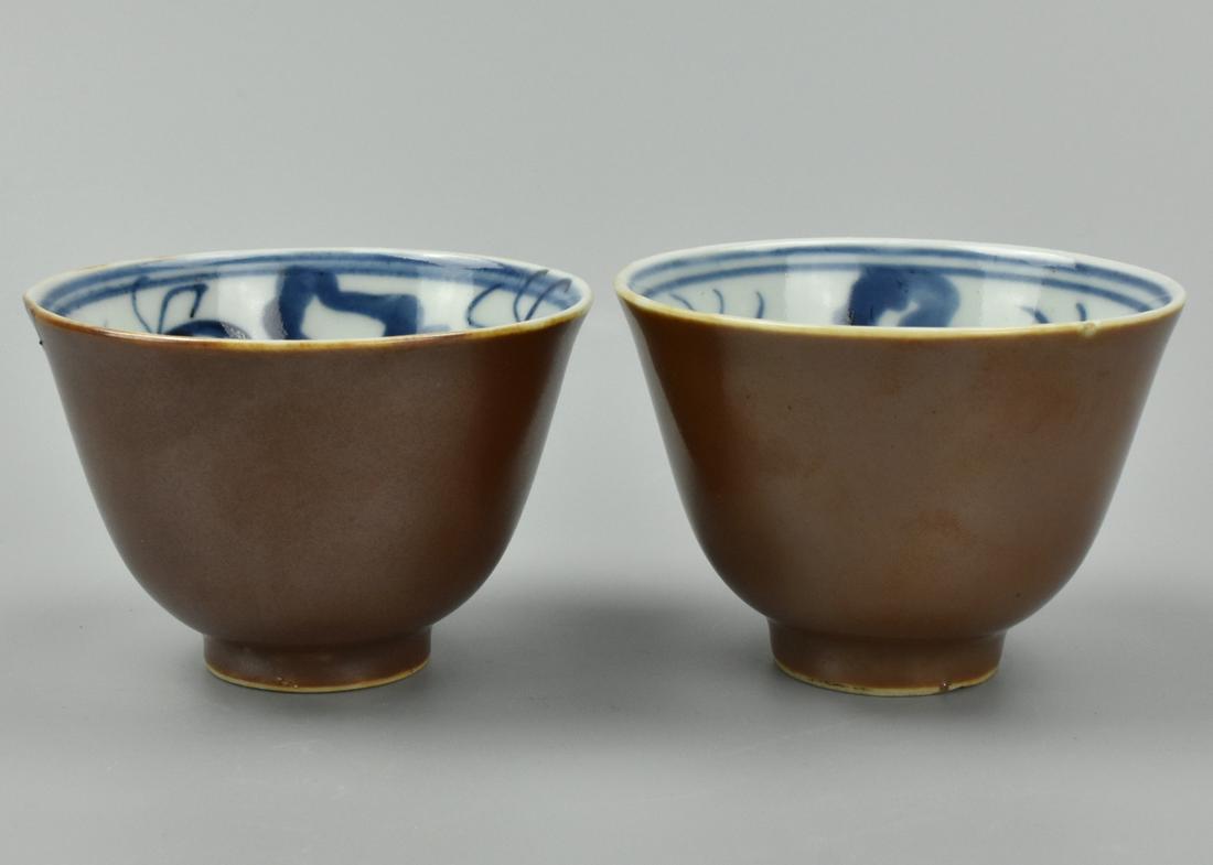 Pair of Chinese Brown, & Blue & White Cups,19th C.: A pair of matching, Chinese, porcelain cups of inverted bell shape, the interiors with loose blue & white splashes, the exteriors an even pearlescent umber. D: 2 7/8" (7.3cm) Condition: One with a fle