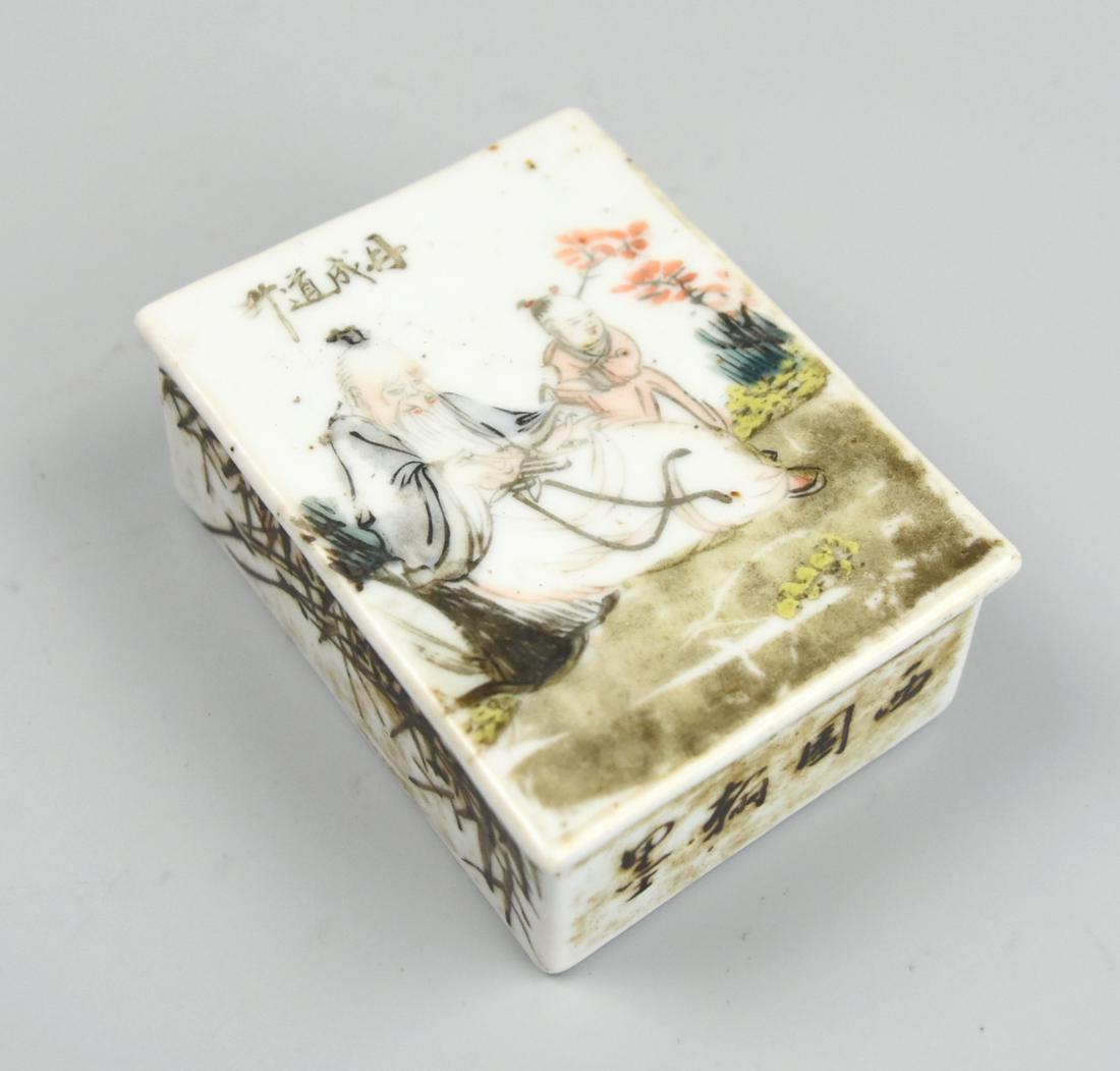 Chinese Qianjiang Box & Cover w/ Scholar,20th C.: A rectangular Chinese Famille Rose porcelain box with lid showing a scholarly old man sitting beside a young child in a flowering garden. Four Chinese characters are written above the man`s head as we
