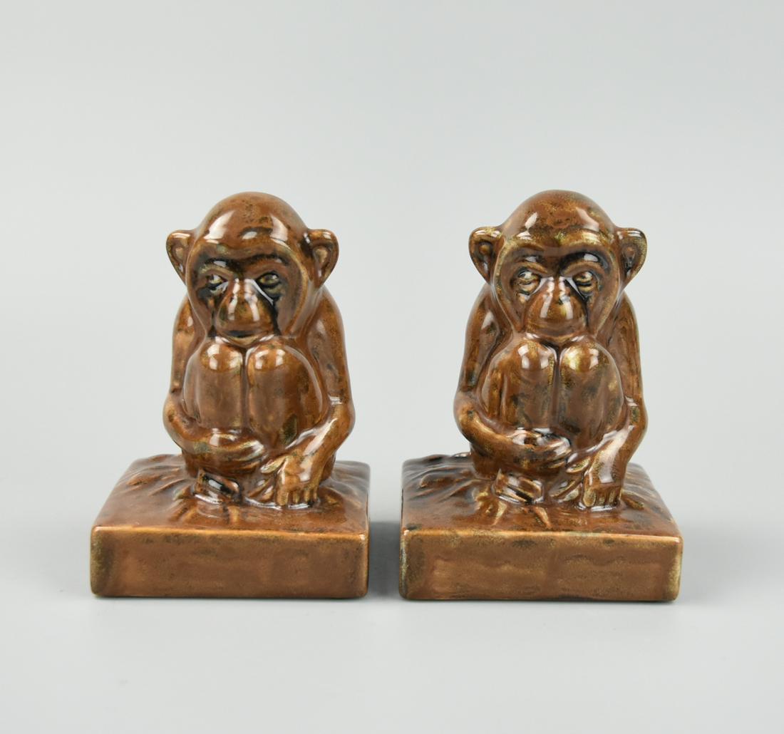 A pair of Rookwood Figural Monkey: A pair of limited edition glazed Rookwood monkey figures seated on a quadrilateral square base. Covered with brown matte glaze. With Rookwood Flame Logo 1985 marked on bottom. (35 years old) H: 4 5/8"