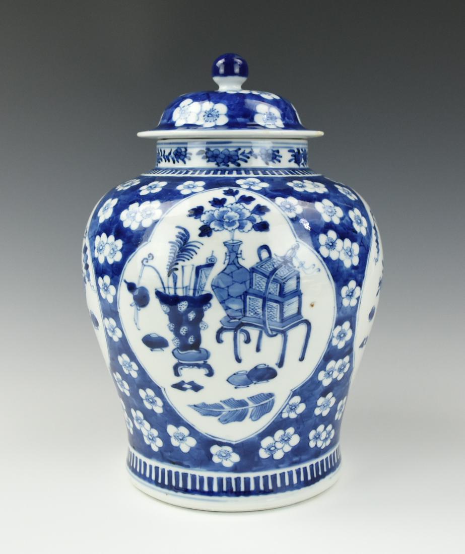 Large Chinese Blue & White Jar and Cover, 19th C.: Chinese ,19th C,of ovoid form with broad shoulders, decorated with petal-shaped floral panels, depicting Chinese antique against plum flower ground, the cover with bud finial with underside of four Ch
