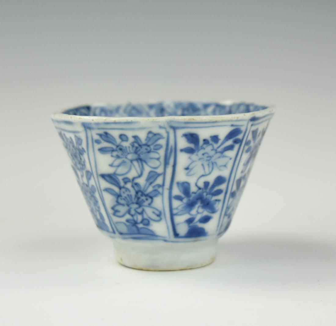 Chinese B & W Octagon Cup w/ Flower, Kangxi Period: Chinese, Kangxi Period ,the eight-sided beaker standing on flat foot and flaring to a rim of conforming shape, decorated around the body on each side with a lotus wreathed by feathery scrolls, the blo