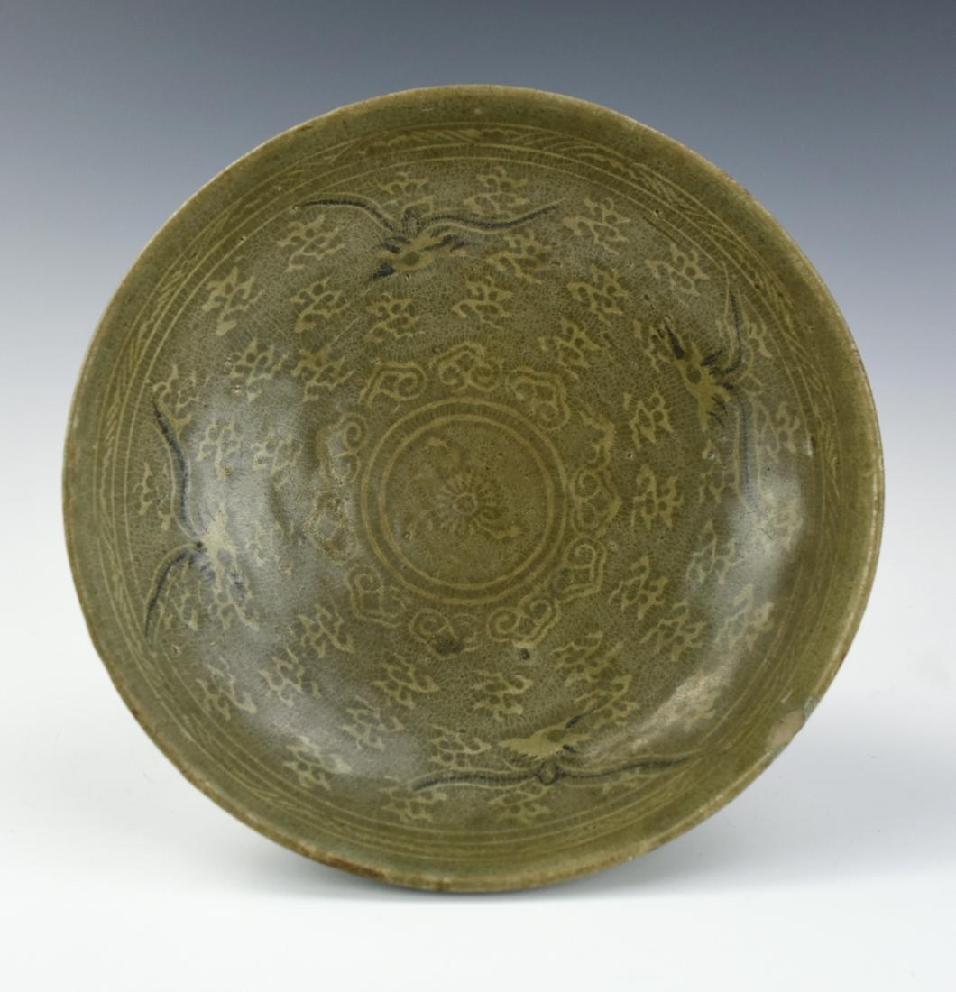 Korean Celadon Glazed Bowl w/ Crane, 15-16th C.: the interior with four wide bands of lotus flowers and four flying crane beneath a decorative border, the exterior with white roundels, surrounded by two double circle within H: (6.8cm), D: (19.7cm) P