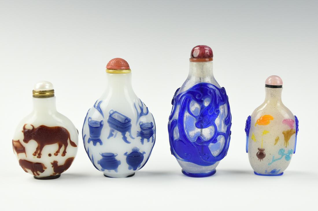 Four Chinese Glassware Snuff Bottles: four Chinese ,20th C,snuff bottle 1, blue glass overlay of Chi Dragon bottle with a purple stopper 2,a white ground blue-color of Chinese antique overlay glass bottle with a coral red stopper 3, a whi