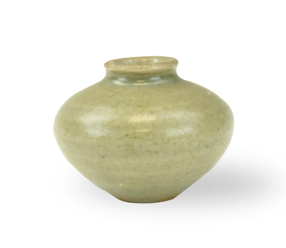 Chinese Longquan Celadon Water Pot, Ming Dynasty: Chinese ,Ming dynasty, of compressed globular form, covered overall in a sea-green glaze,crazing crackle throughout, leaving the unglazed base fired buff-orange H: 2.4"(6cm) W:3.1" (8 cm) collection o
