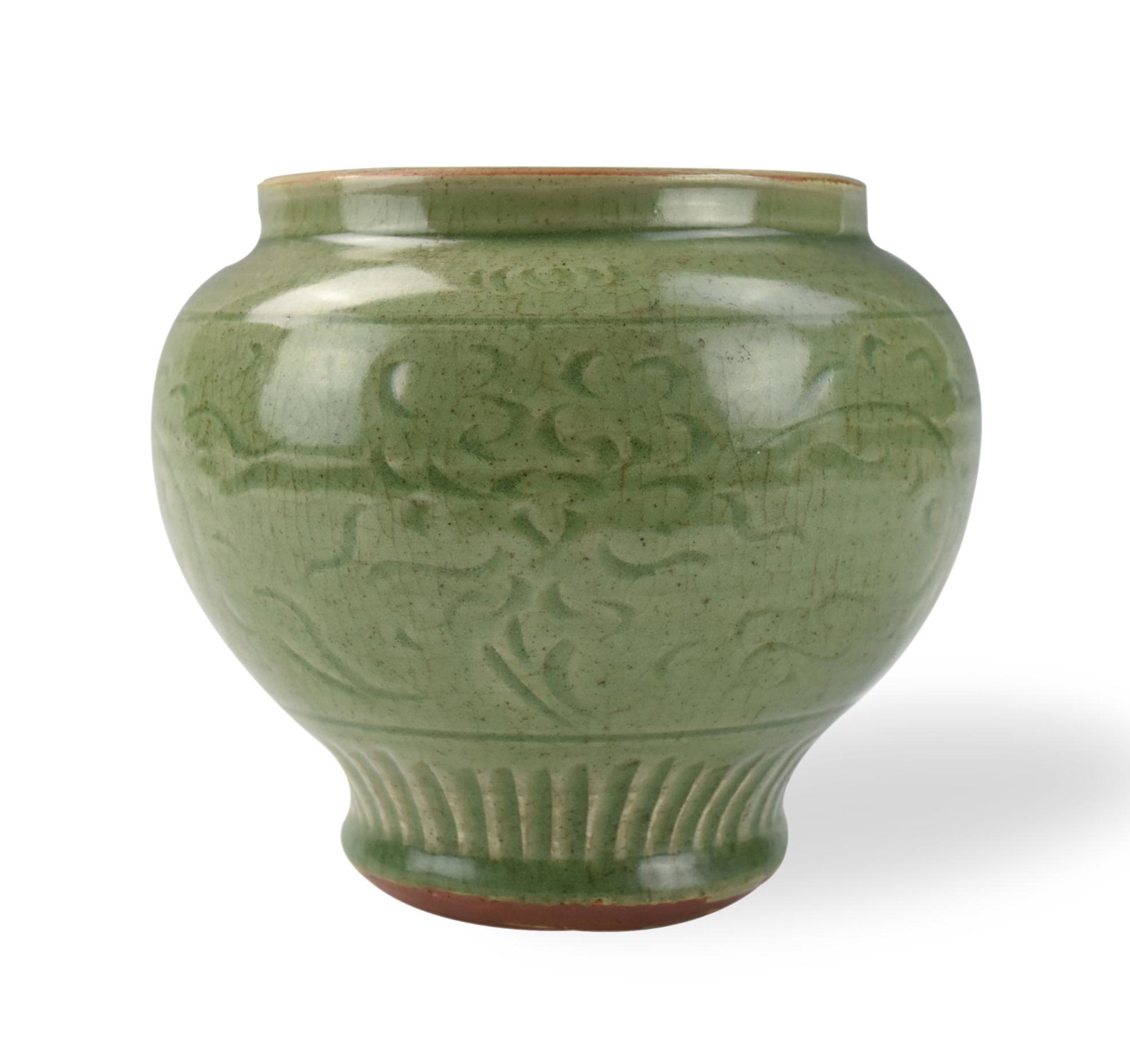 Chinese Longquan Celadon Jar ,Ming Dynasty: Chinese ,Ming Dynasty, sturdily potted and rising to a broad rounded shoulder, the exterior carved with an upper frieze enclosing floral scrolls above an upright lappet border H: 6.3"(16cm) D: 7.3"(18