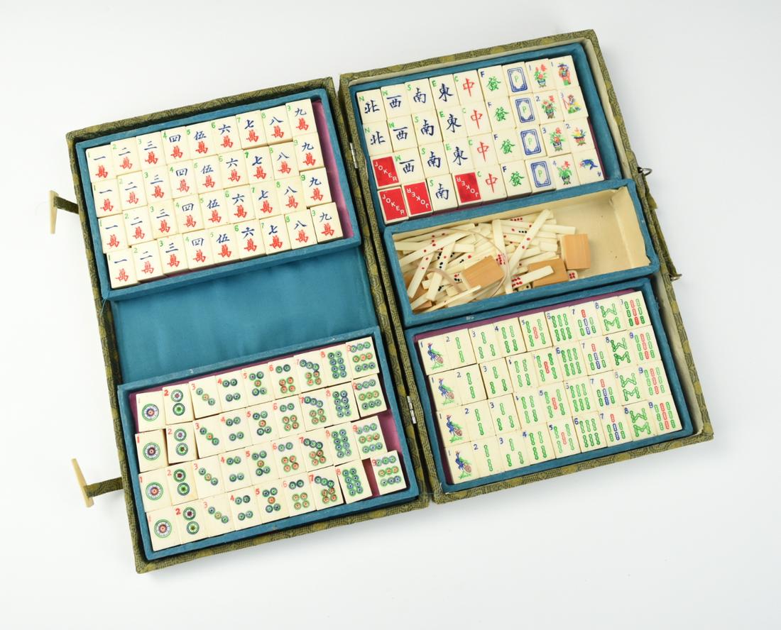 Set of Antique Chinese Mahjong w/ Case: a Chinese ,late Qing D, 148 tile Mahjong set with 58 marked rods, 2 small dices, and 3 circular discs reading : north, east ,& west, within 5 removable compartment, in a patterned green, cloth covered