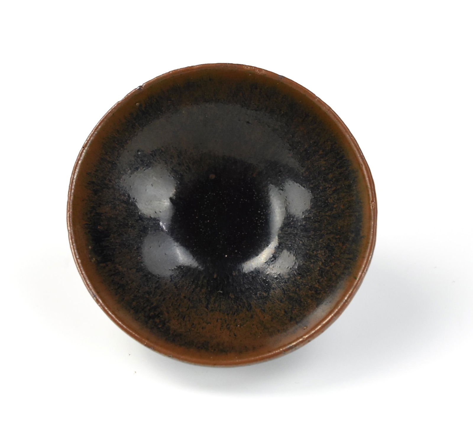 Chinese Jian Ware Tea Cup, Song Dynasty: Chinese ,Song Dynasty, potted with shallow rounded sides supported on a short splayed foot, covered overall in an unctuous glossy black glaze evenly suffused with small brownish 'oil spots' of varying