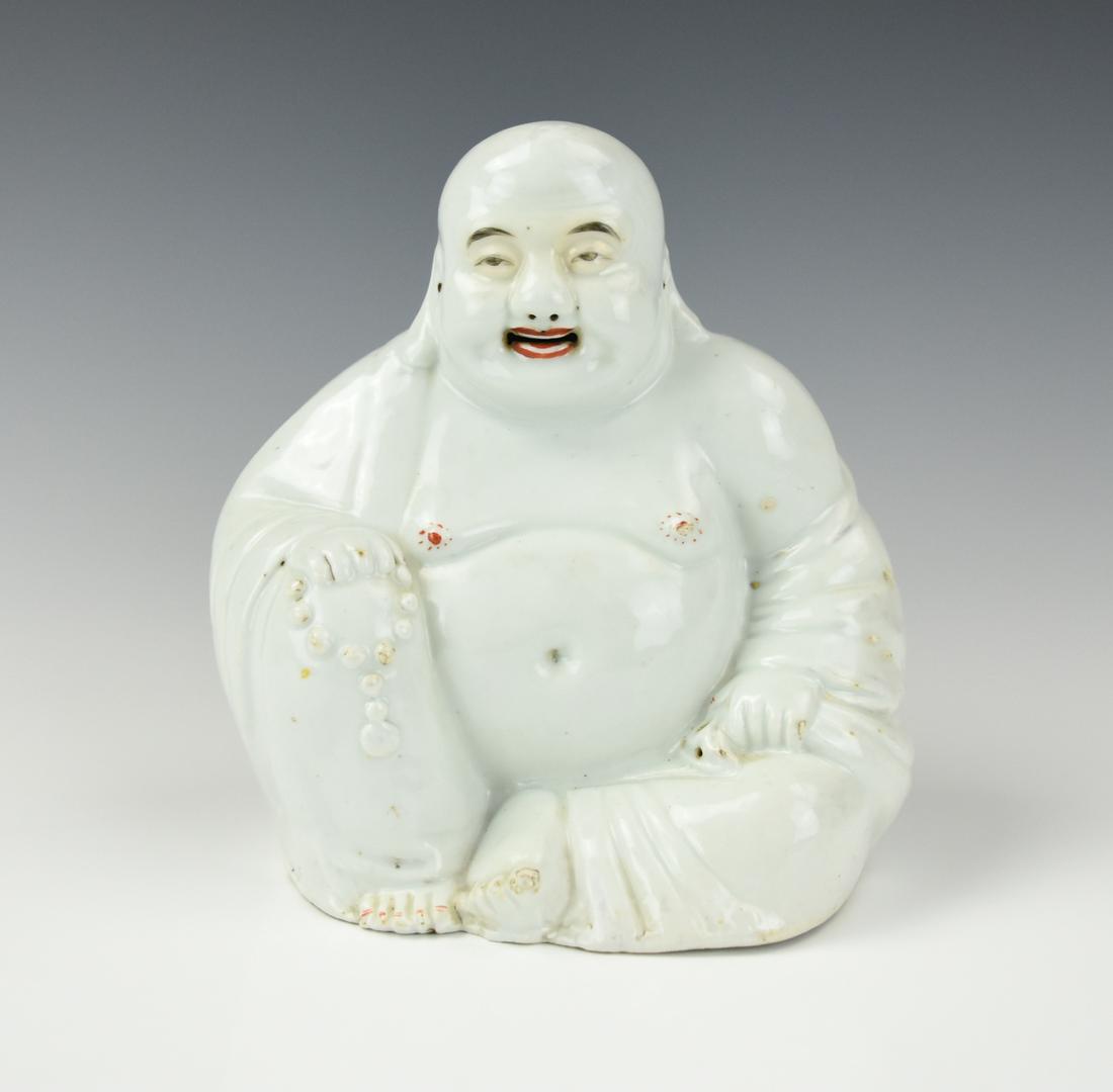 Chinese Porcelain White Glazed Buddha, ROC Period: Chinese ,ROC Period , a serene and smiling Buddha figure seated with a chain of prayer beads in his hand, covered in white glaze H: 7 3/4"(19.5cm), D: 6 7/8"(17.5cm) Condition: It is in very good cond