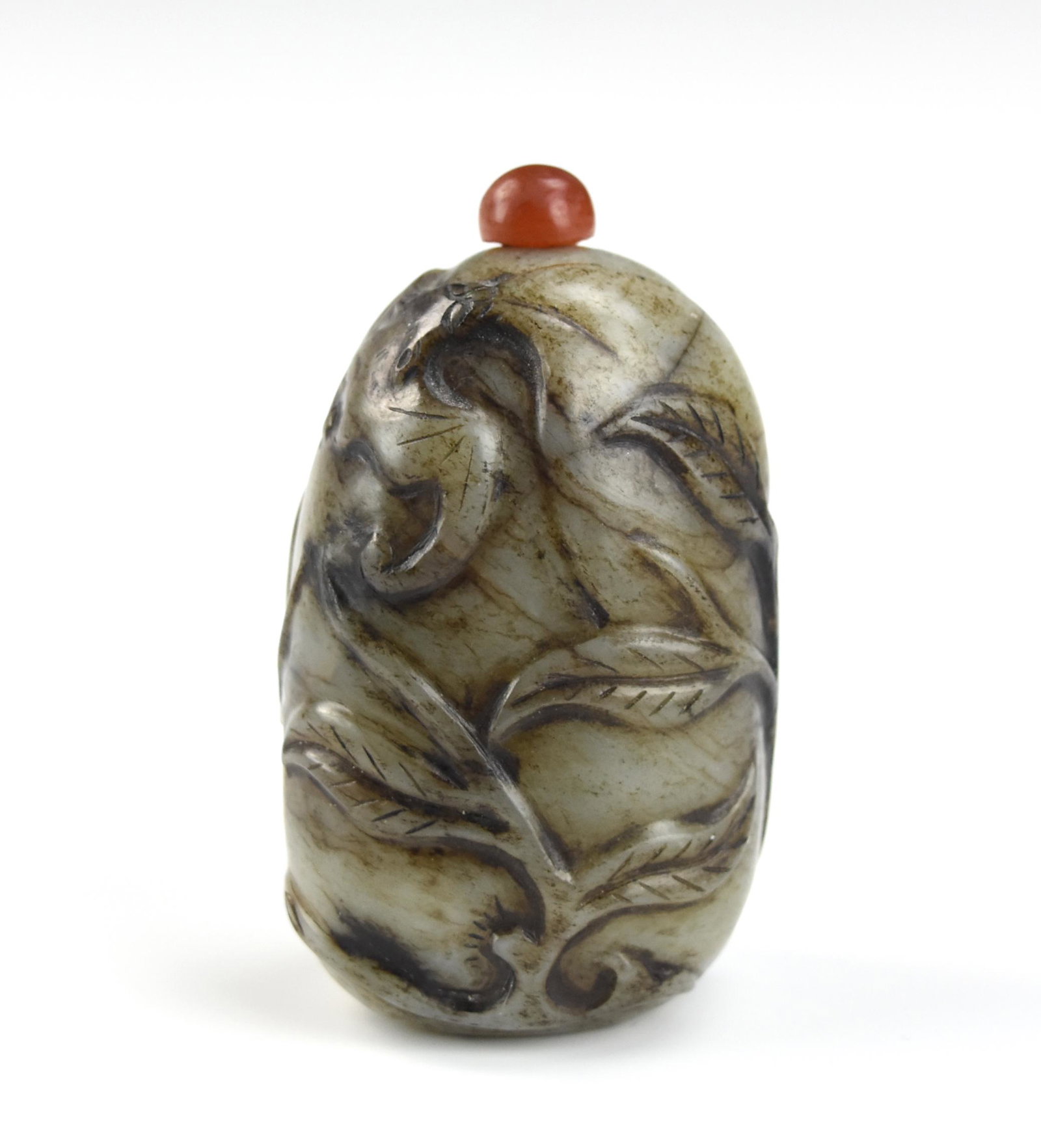 Chinese Jade Snuff bottle w/ Bat & Foliage: Chinese celadon jade snuff bottle carved with bat and scrolling foliage, come with a tiny coral stopper D: 3.1/8 "(7.9cm) Condition: The bottle is in overall good condition with some natural fissures 
