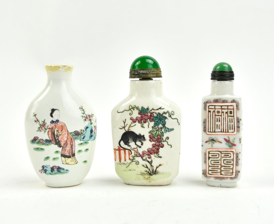 Three Chinese Porcelain Snuff Bottles: one porcelain bottle painted with fruits, plants and a rat on one side, the other side is decorated with two fishes in iron red with green reefs on a white ground, jade stopper with a metal band one p