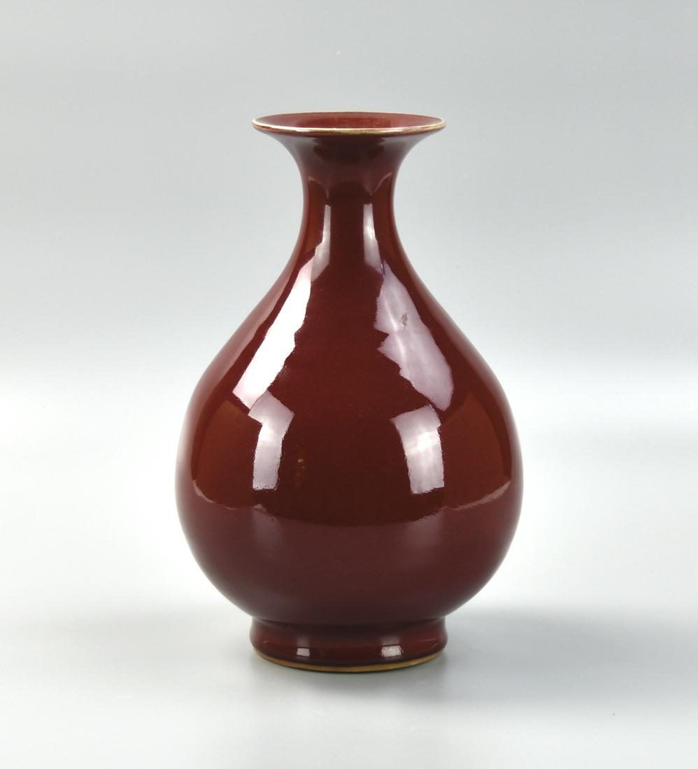 Chinese Copper-Red Glazed Vase: Chinese ,19-20th C,well potted with a pear-shaped body rising from a splayed foot to a tall waisted neck flaring at the rim, the exterior covered in a rich dark red glaze pooling to a deeper tone arou