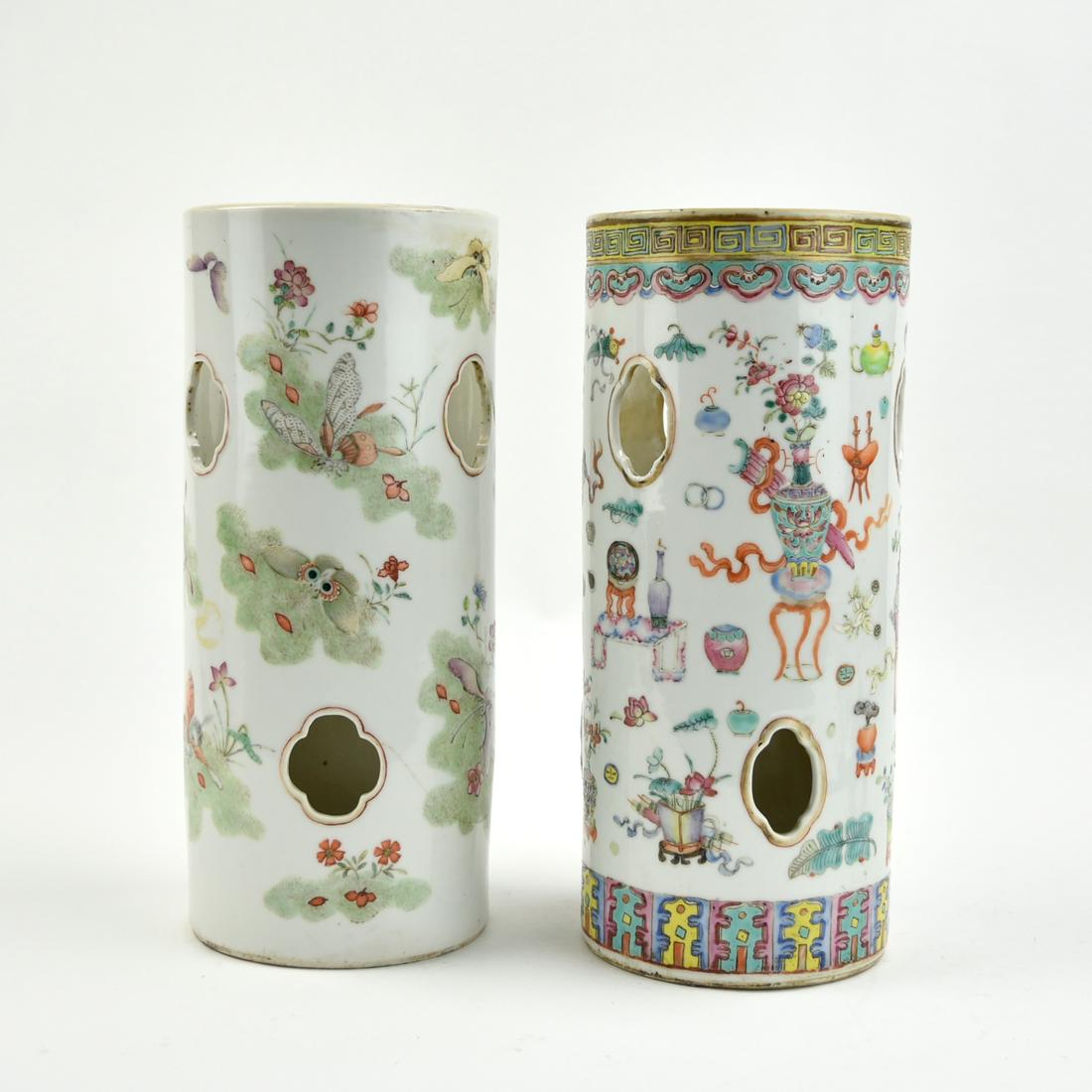 Two Chinese Famille Rose Hat Vases, 19th C.: Chinese ,19th C, cylindrical, famille rose, Chinese, porcelain hat stand, with quatrefoil windows and illustrations of a lappet band at the base with a ruyi band at the top. Body decorated with vases,