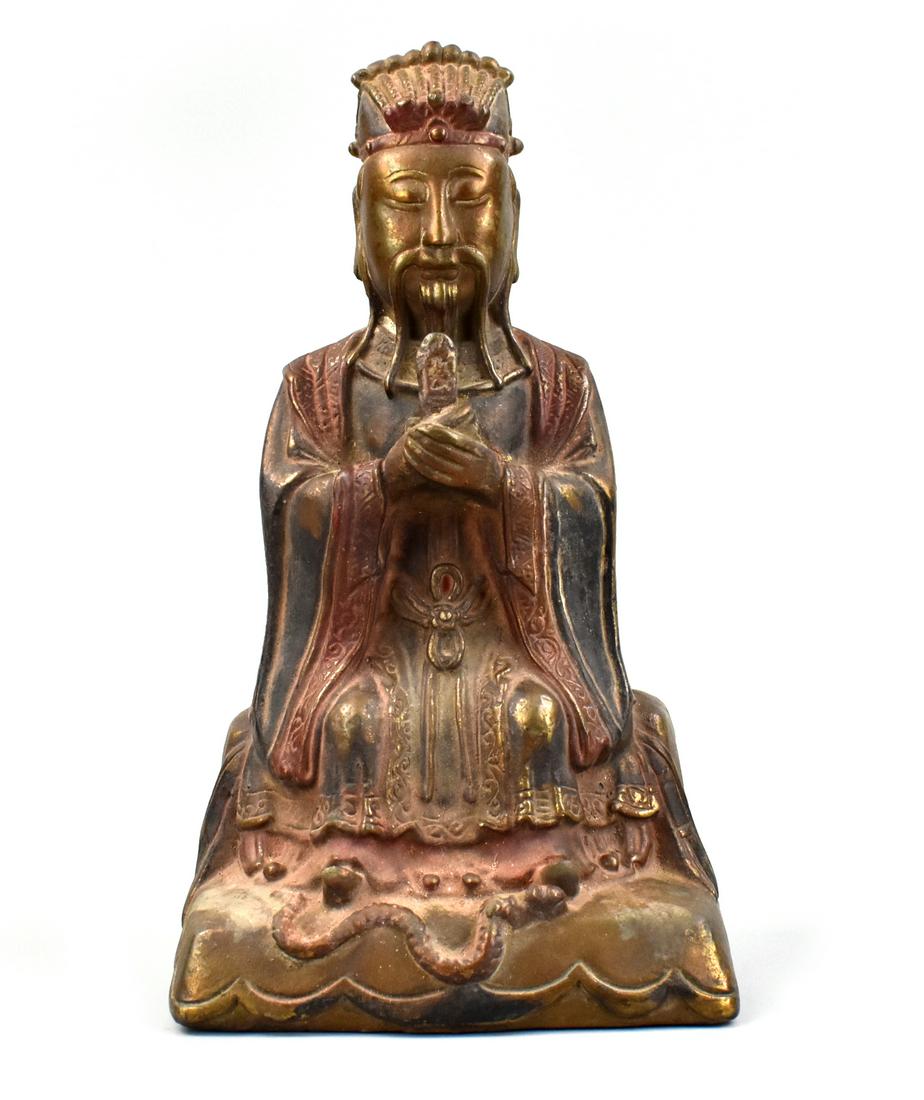 Chinese Gilt Lacquer Coated Bronze Figure,Qing D.: A seated Chinese ,Qing Dynasty, bronze figure coated in lacquer and originally painted. The robed figure gazes downwards with eyes closed and clasps his hands holding an upright object. Beneath his fe