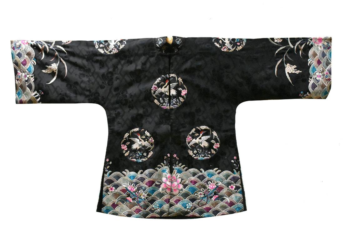 Chinese Embroidery Women Cloth,Qing Dynasty: A Chinese embroidery tunic surcoat for a woman, dating from the Qing dynasty. Woven design on textured black silk, circular medallions with a white crane, with a water wave motif on edges of sleeves a