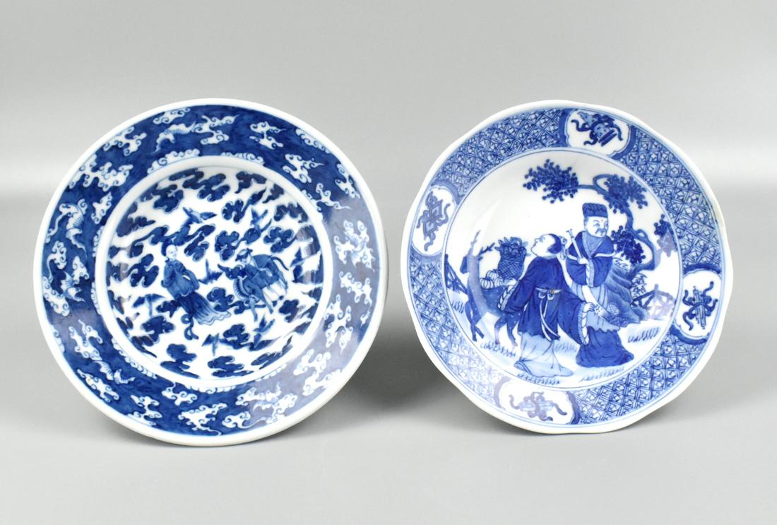 2 Chinese B & W Plate w/ Figures: Two Chinese blue & white plates with figures. One plate slightly larger, both with central figures inside with decorated band inside. Two figures with a basker and a deer on one plate with the band se