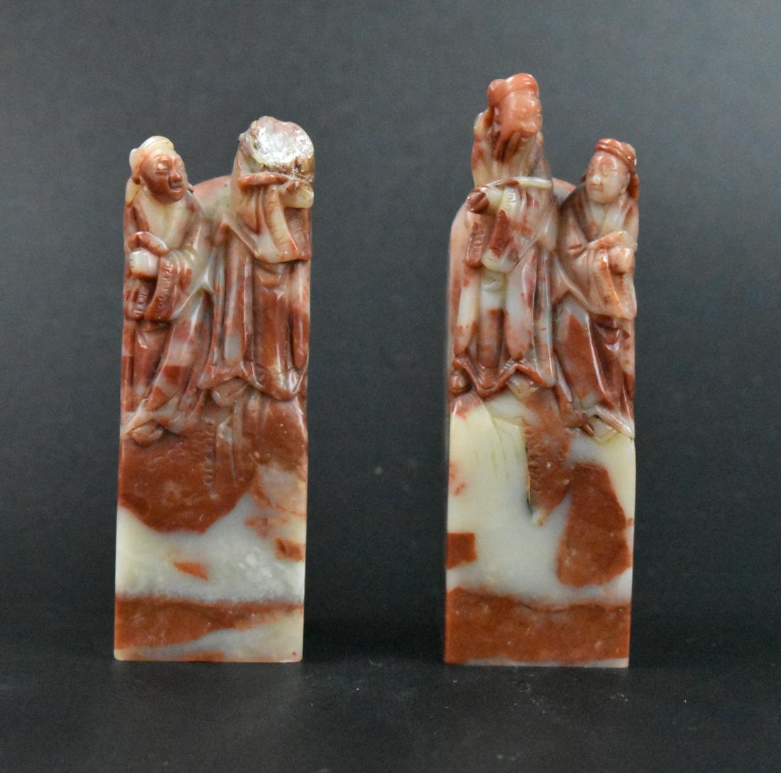 Pair of Chinese Soapstone Carved Seal w/ Figure: A pair of Chinese soapstone carved seals with carved figures. Two square shaped seals carved in soapstone, each with two robed figures on the top. One stamp in English: "Roberta & Baker" and one with 
