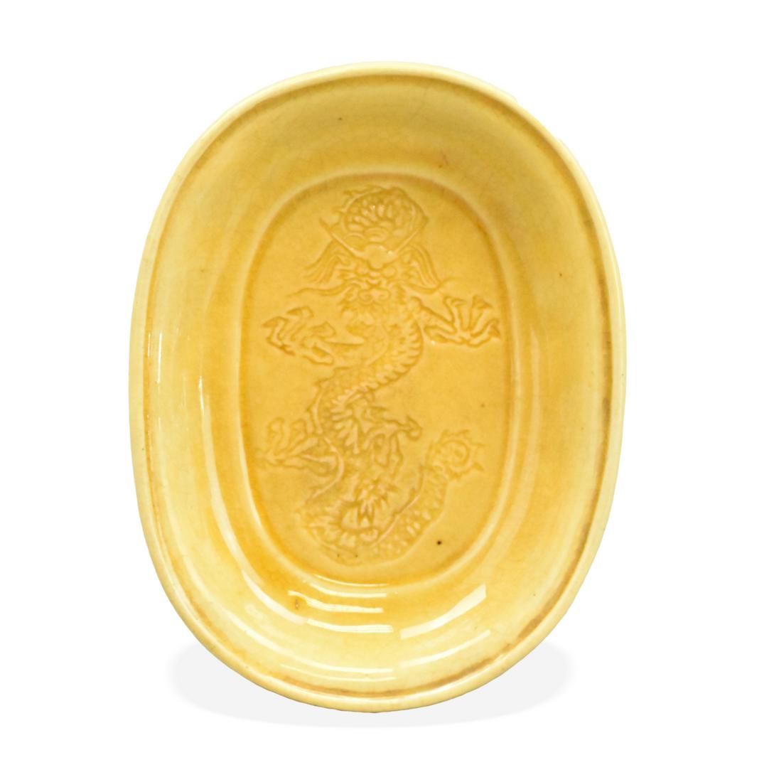 Chinese Yellow Glazed Dragon Waterpot, 19th C.: A Chinese yellow glazed dragon waterpot, dating from the 19th century. An oval shaped waterpot with deep angles sides and a small rim. On bottom an incised single dragon design. L. 3 5/8" (9.2 cm) Con