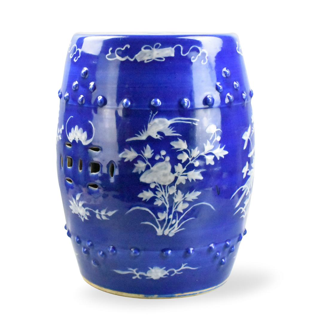 Chinese Blue and White Garden Seat, 19th C.: A Chinese blue and white garden seat. The design featuring four water plants in white glaze with birds flying, and bats in white. The top also has four plants, spaced evenly. Decorative cut out holes 