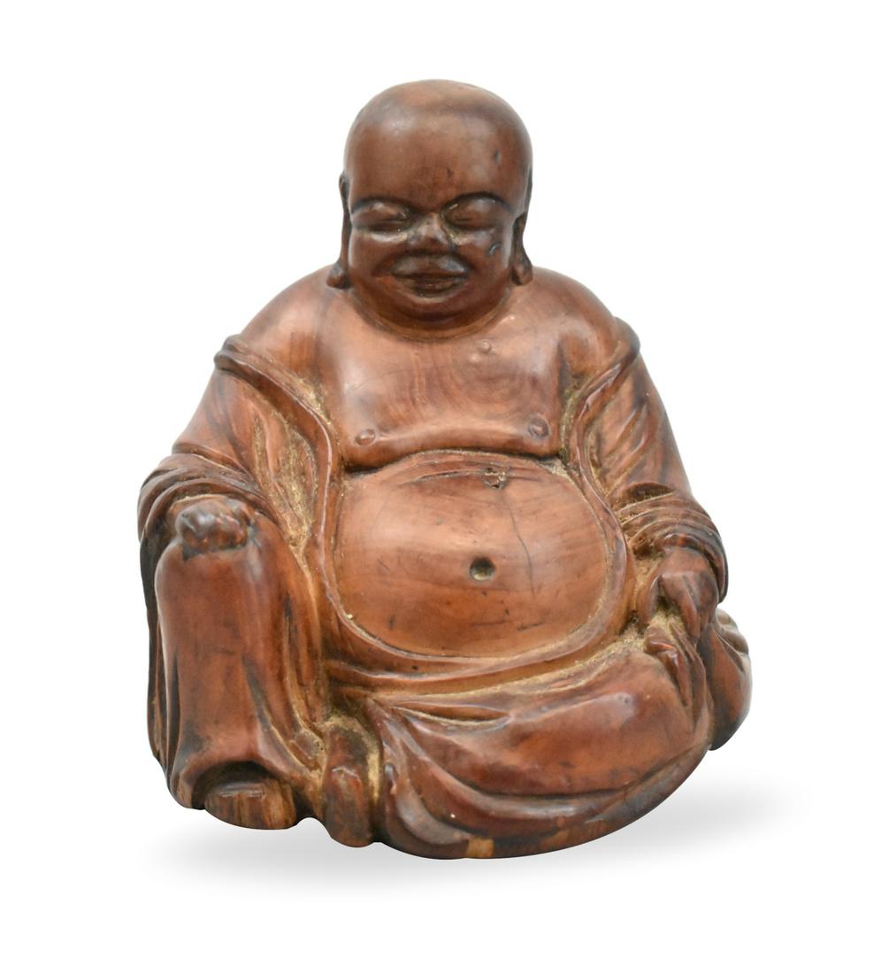 Chinese Wood Carved Buddha Figure,Qing Dynasty: A Chinese wood carved buddha figure, dating from the Qing dynasty. The buddha is seated with his robe open, his head tilted downwards with eyes closed and a placid expression on his face. H. 3" (7.6 c