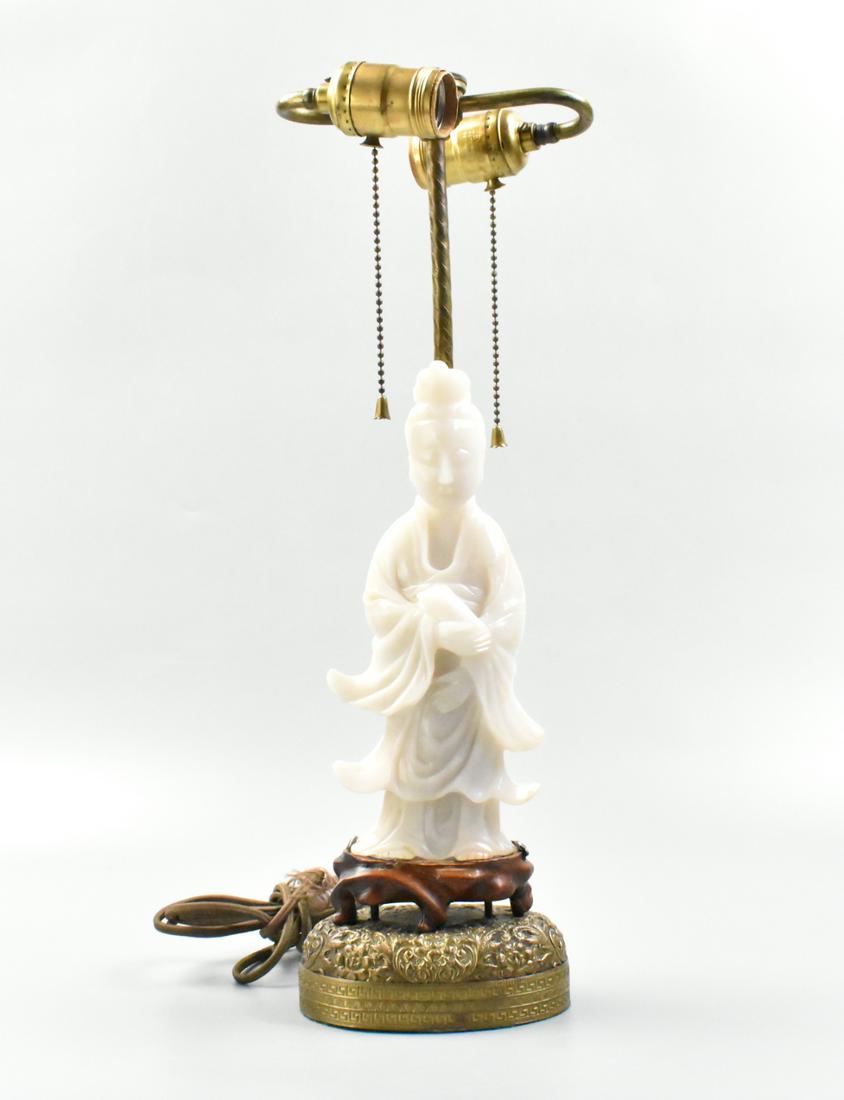 Chinese Jade Carved Guanyin Figure, MAL: A Chinese jade carved Guanyin figure, MAL. The figure is mounted as a lamp, and is smoothly carved with layers of robes flowing, bare feet visible at the base. Her head is tilted slightly forward. Fig