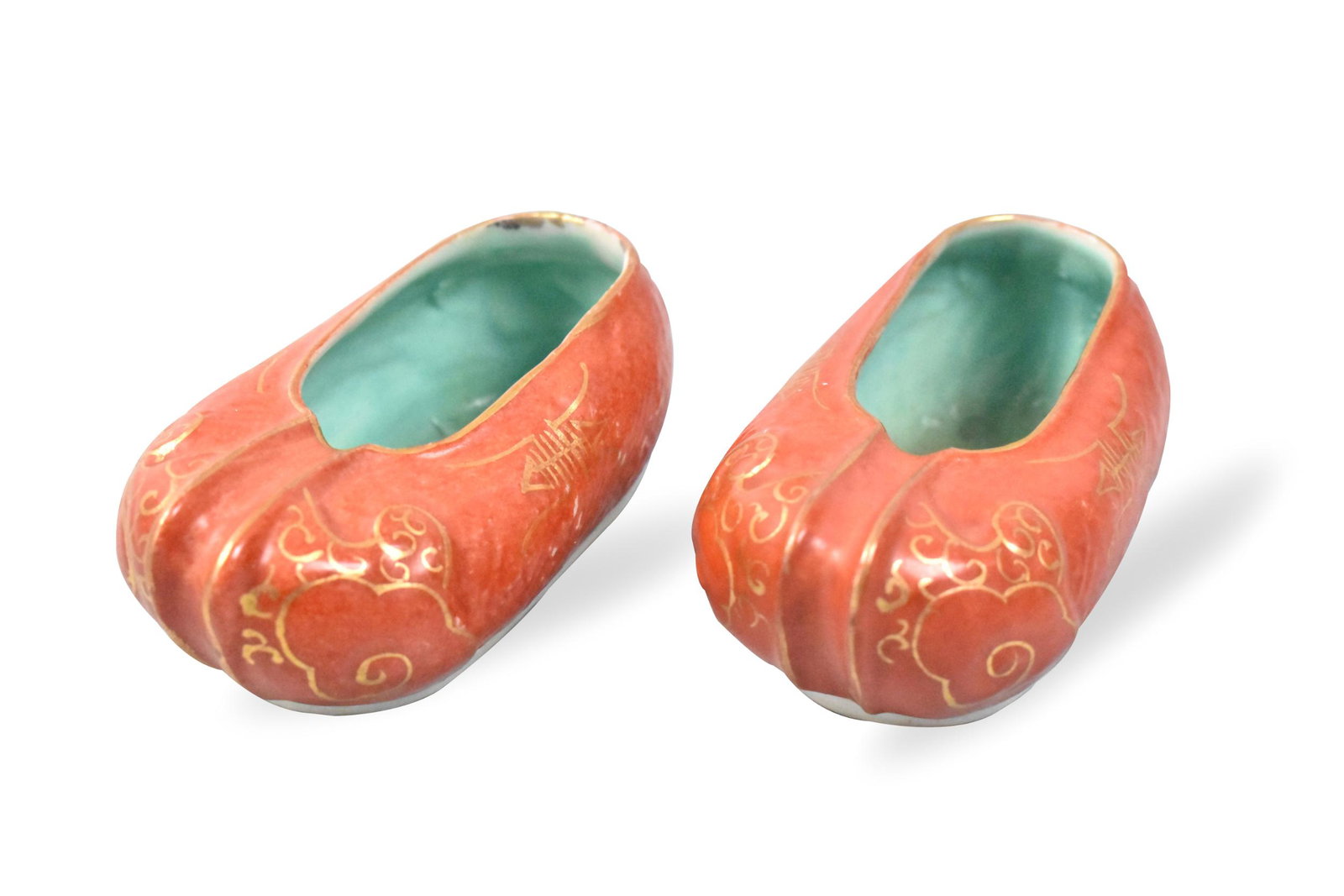Pair Chinese Gilt Coral Red Porcelain Shoes,ROC P.: A pair of Chinese Gilt coral red porcelain shoes. dating from the Republic Period, Each tiny coral red shoe and raised design at the front and back, with detail of swirling gilt shapes. The glaze ends