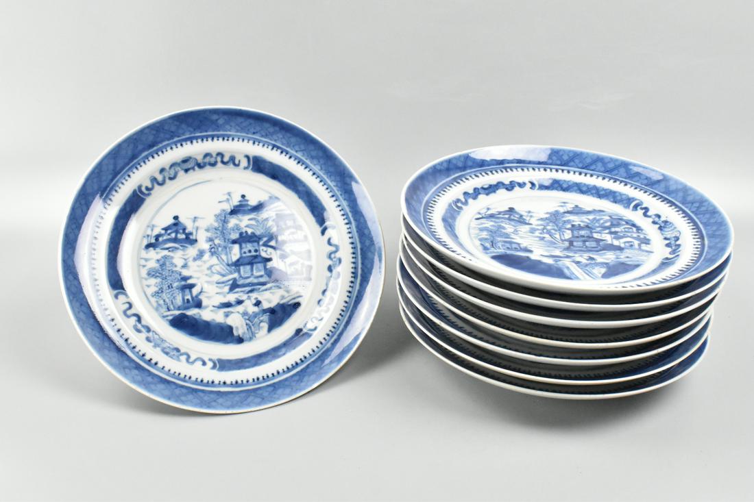 Group 8 Chinese Export Blue & White Plates,19th C.: group of 8 Chinese blue and white plates, each with a central Chinese landscape featuring water, bridge, houses, trees, and a figure. Surrounded by a tiered cheek of blue and white design and a blue b