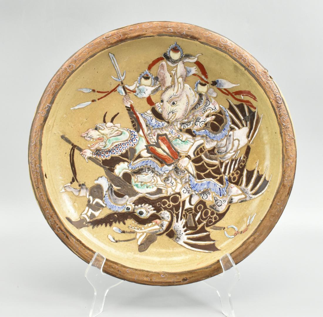 Japanese Studio Porcelain Charger With Rabbit: A Japanese studio porcelain charger with rabbit design.Meiji Period, The textured pottery fesign is raised and features an animated scene of a warrior rabbit with a spear and fierce expression riding 