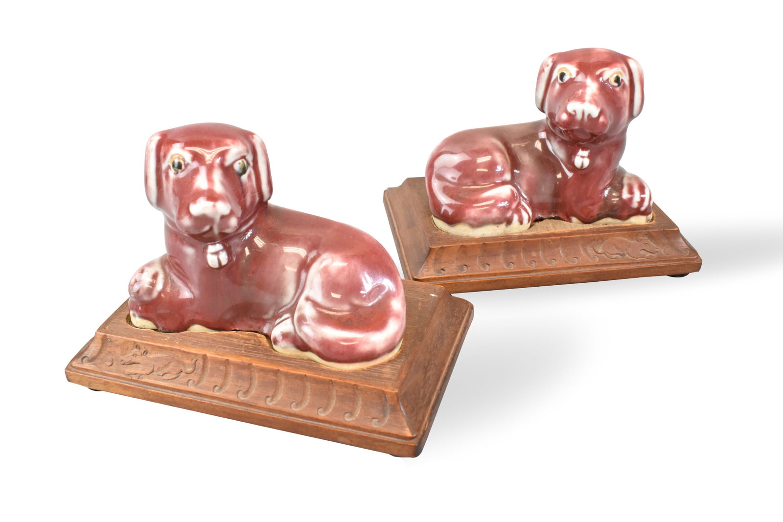 Pair of Chinese Flambe Dog Figure on Stand,19th C.: A pair of Chinese flambe dog figures on wooden stands, dating from the 19th century. Red flambe glaze on each seated dog, with lighter highlights around the eyes, nose, and ears.base remain unglaze, b