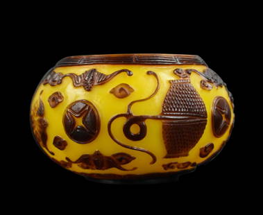 Chinese Peking Glass Water Coupe,Qing Dynasty: A Chinese Peking glass water coupe decorated with raised Chinese table articles, antiques, and auspicious bats. Dark red design over the milky yellow ground. Decorative band of rings around the mouth.