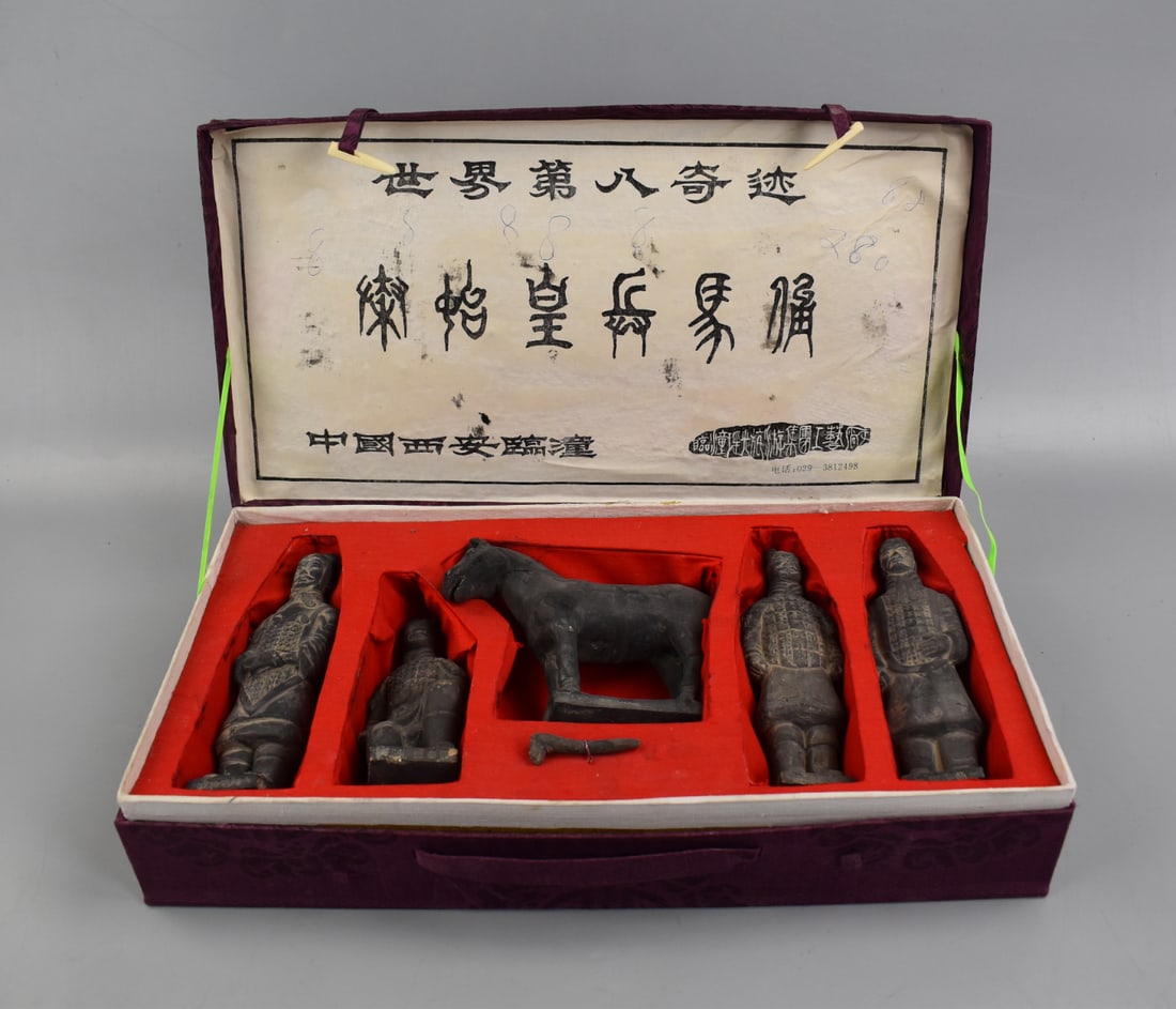 Set of Chinese Terracotta Warriors and Horses: A boxed set of Terracotta Warriors and a Horse. Three standing warriors and one kneeling in full detailed battle regalia. A standing horse and a small weapon of some kind, all arranged in their own ar