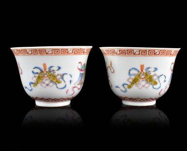 Pair of Chinese Famille Rose Cups,ROC Period: A pair of Chinese famille rose cups, dating from the Republic period. cups have white interior and famille rose design of Chinese auspicious items on body Each with a six red character mark on the rec
