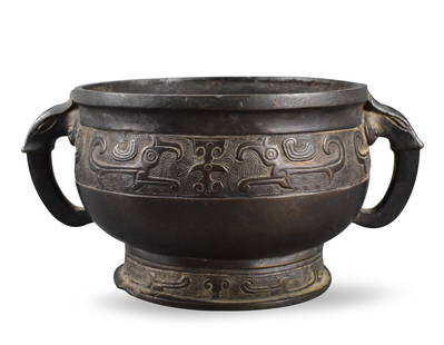 Chinese Archaic Bronze Cast Censer, Qing Dynasty: A Chinese archaic bronze cast censer, dating from the Qing dynasty.compressed body standing on rounded splayed foot ,adorned with a band of archaic Chi dragon theme around the body and base, flanked b