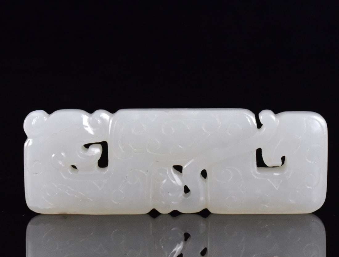 Chinese White Jade Carved Dragon Pendant, 19th C.: A Chinese white jade dragon form pendant. dated from 19th C, The pendant is rectangular with lightly incised archaic clouds design on both sides L. 1 3/4" ( 4.4 cm), W. 5/8" (1.5 cm) Provenance: Estat