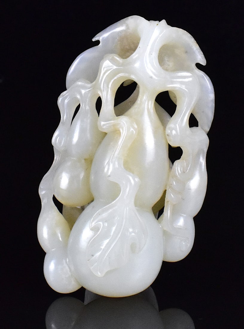 Chinese Jade Carved Toggle of Gourd, 19th C.: Chinese jade carved toggle of double gourd, dated from 19th C. a reticulated grouping of 4 gourd, one large three smaller, connecting by branches and vines, large leaves carved in the back H: 3"(7.5 c