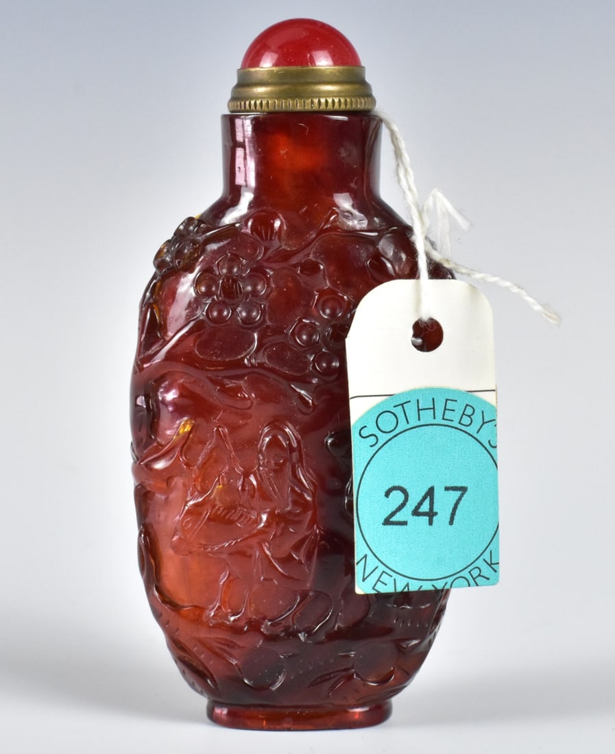 Chinese Amber Carved Snuff Bottle, 18th C.: A Chinese amber carved snuff bottle, dating from the 18th century. carved with design of a man riding donkey on one side and wise figure with two goat on other side. With a rounded peking glass cover