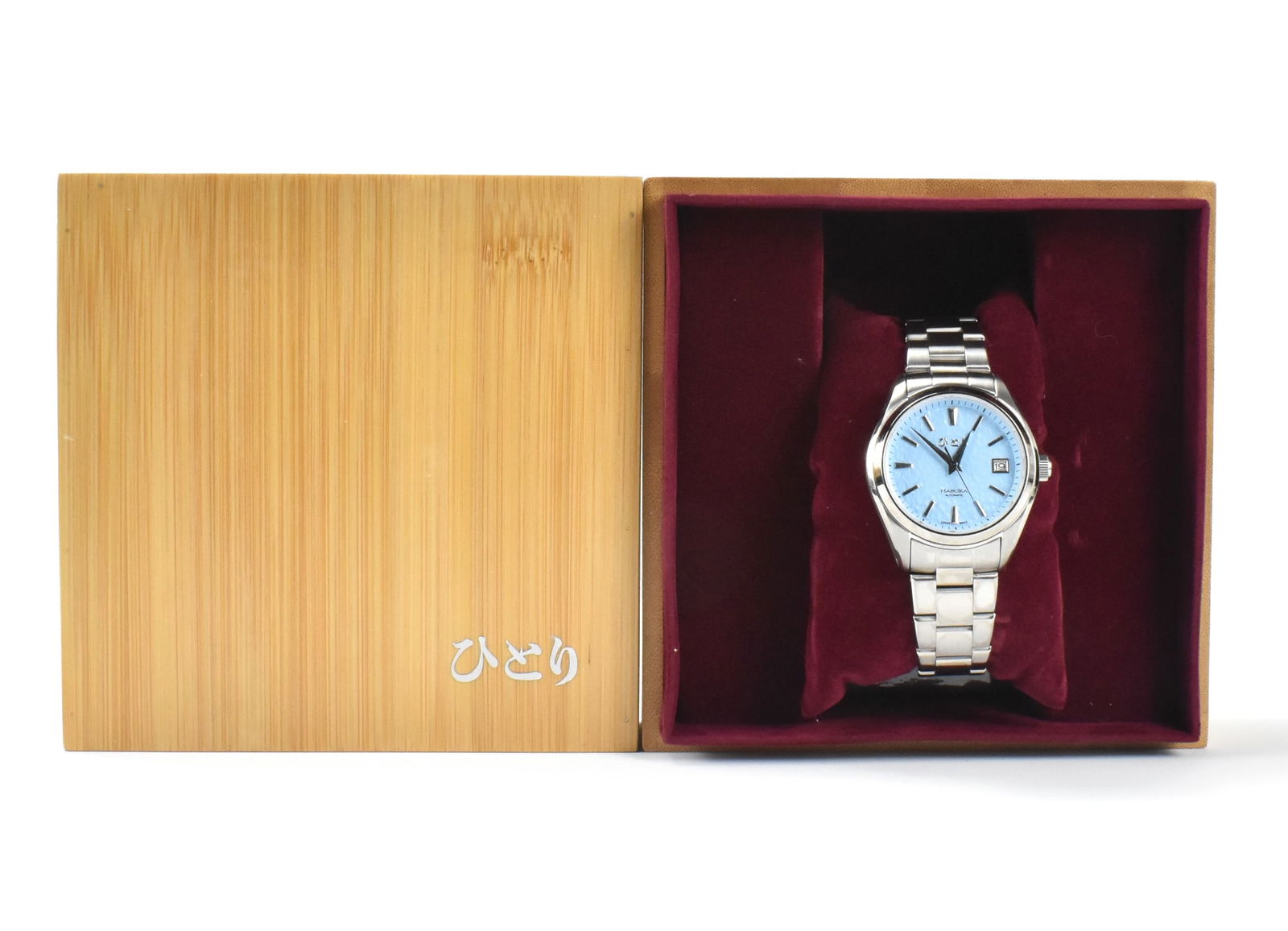 Habuka Japanese Automatic Watch: Habuka Japanese automatic watch with stainless steel band, with Japan movement. aqua blue face,Window on reverse side to see workings. With an ornate square wood box within a cardboard box. Link to