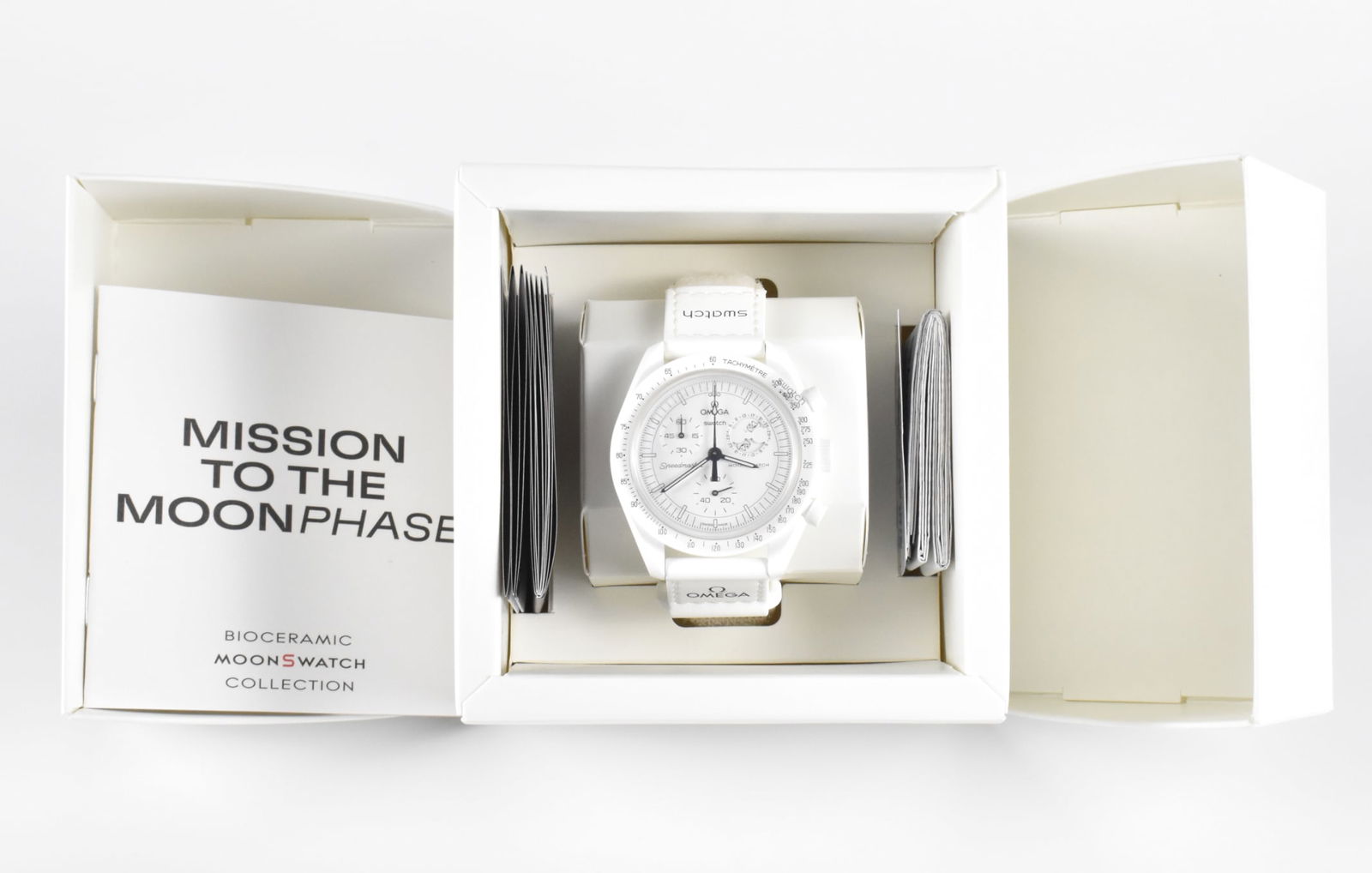 Omega x Swatch Moonswatch Snoopy White Watch: An Omega x Swatch Moonswatch Snoopy White watch. Mission to the Moon Phase. With original box and papers. From the Bioceramic MoonSwatch collection. Link to HD Natural Light photos:Click he