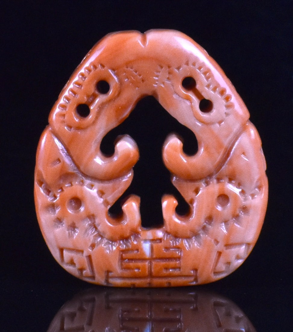 Chinese Coral Carved Plaque, Qing Dynasty: A Chinese coral carved plaque, dating from the Qing dynasty. Orange coral color, heart shaped, with incised, smooth design around sides and auspicious shape cut out in the middle. H. 1 5/8" (4.1 cm)?,