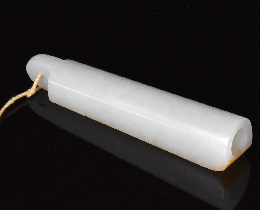 Chinese White Jade Carved Tube, Qing Dynasty: A Chinese white jade carved tube, dating from the Qing dynasty. The white jade tube has a flat side with gold splash and the rest is rounded, expanding slightly from a narrow top to wider bottom. With