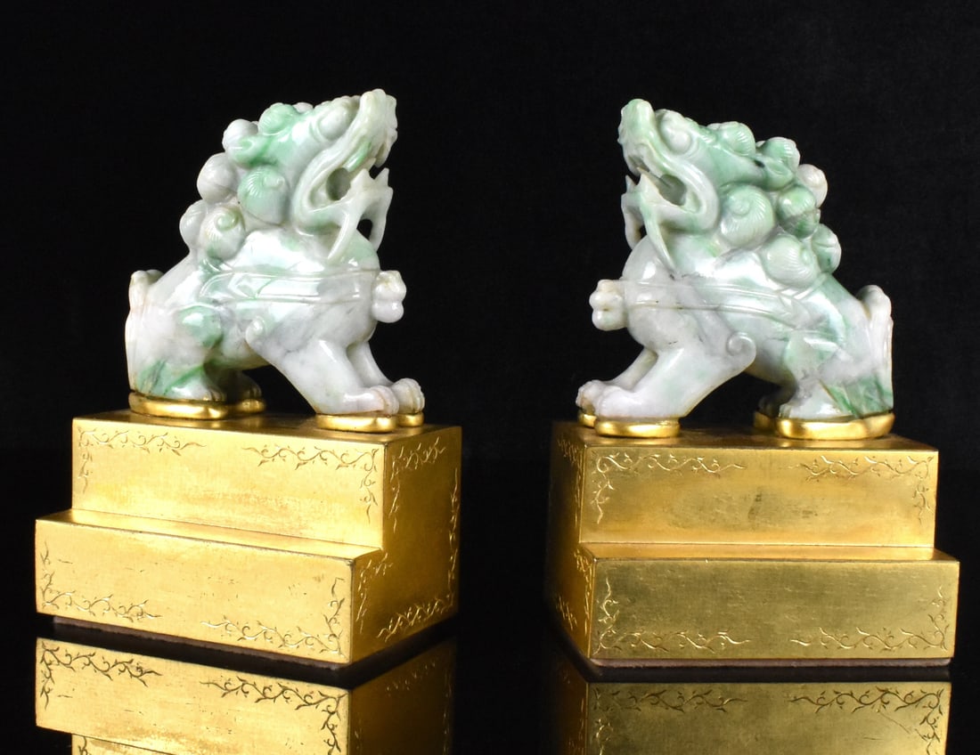 Pair Chinese Jadeite Carved Foo Lions, 19th C.: pair of Chinese jadeite carved foo lion, dated from 19th C. ferocious lion with mouth open, a bell attached at the front neck, standing on four legs on a gild metal pedestal which incised with foliage