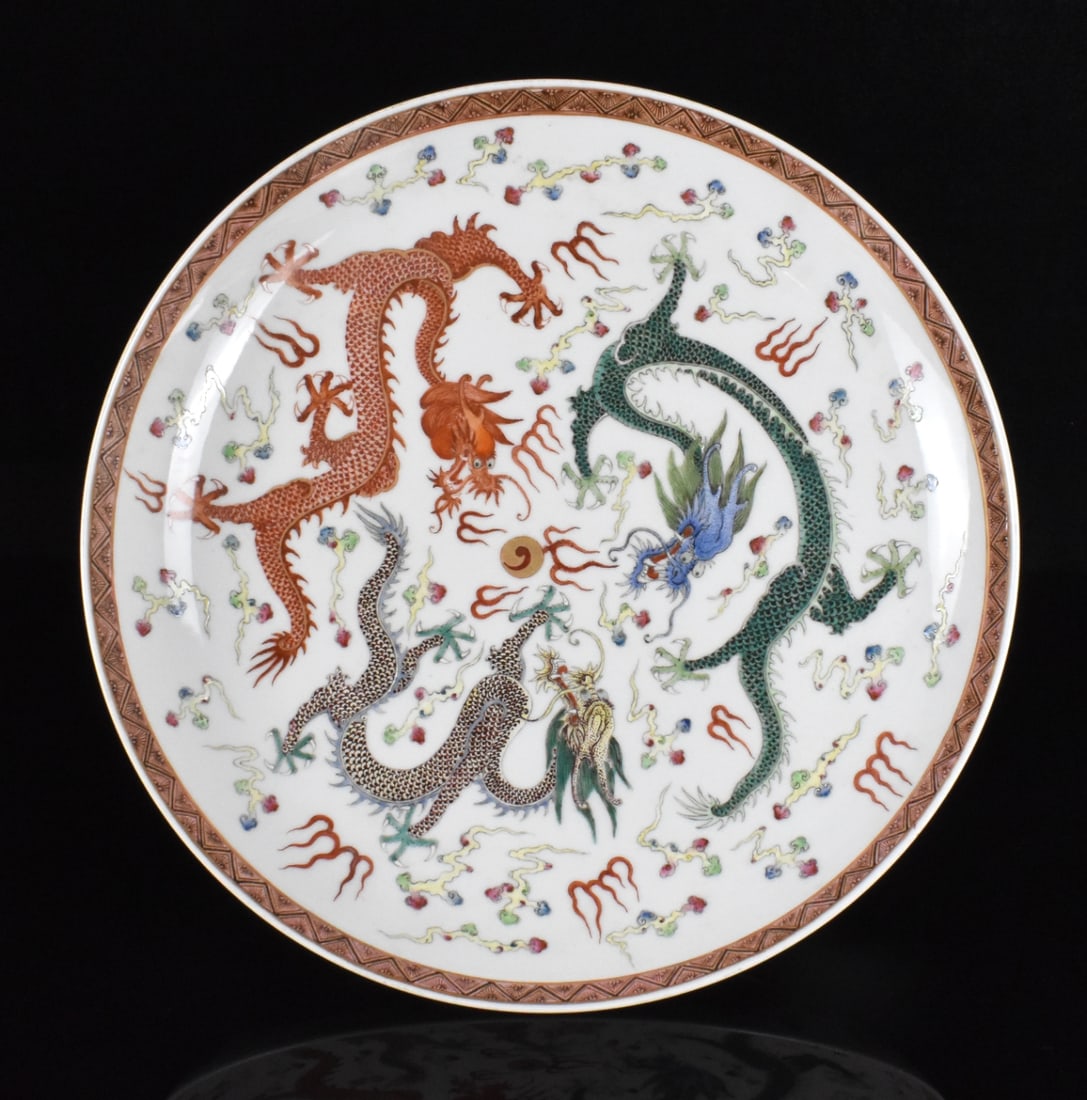 Chinese Famille Rose Dragon Charger,Guangxu Period: A Chinese famille rose dragon charger, dating from the Guangxu period (1875-1908). rounded side charger painted with 3 dragon chasing flaming gilt pearl in colors of green, yellow and red amongst clou