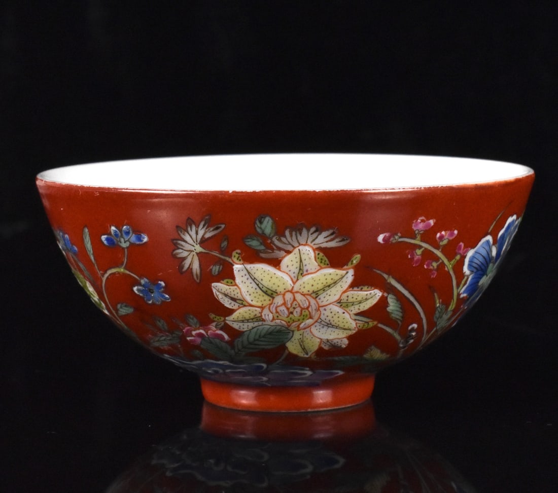 Chinese Coral Ground Famille Rose Cup,Qing Dynasty: A Chinese coral ground famille rose cup, dating from the Qing Dynasty. An exquisite small cup with pristine white interior and painted in brilliant enamels around the exterior with a colorful array of