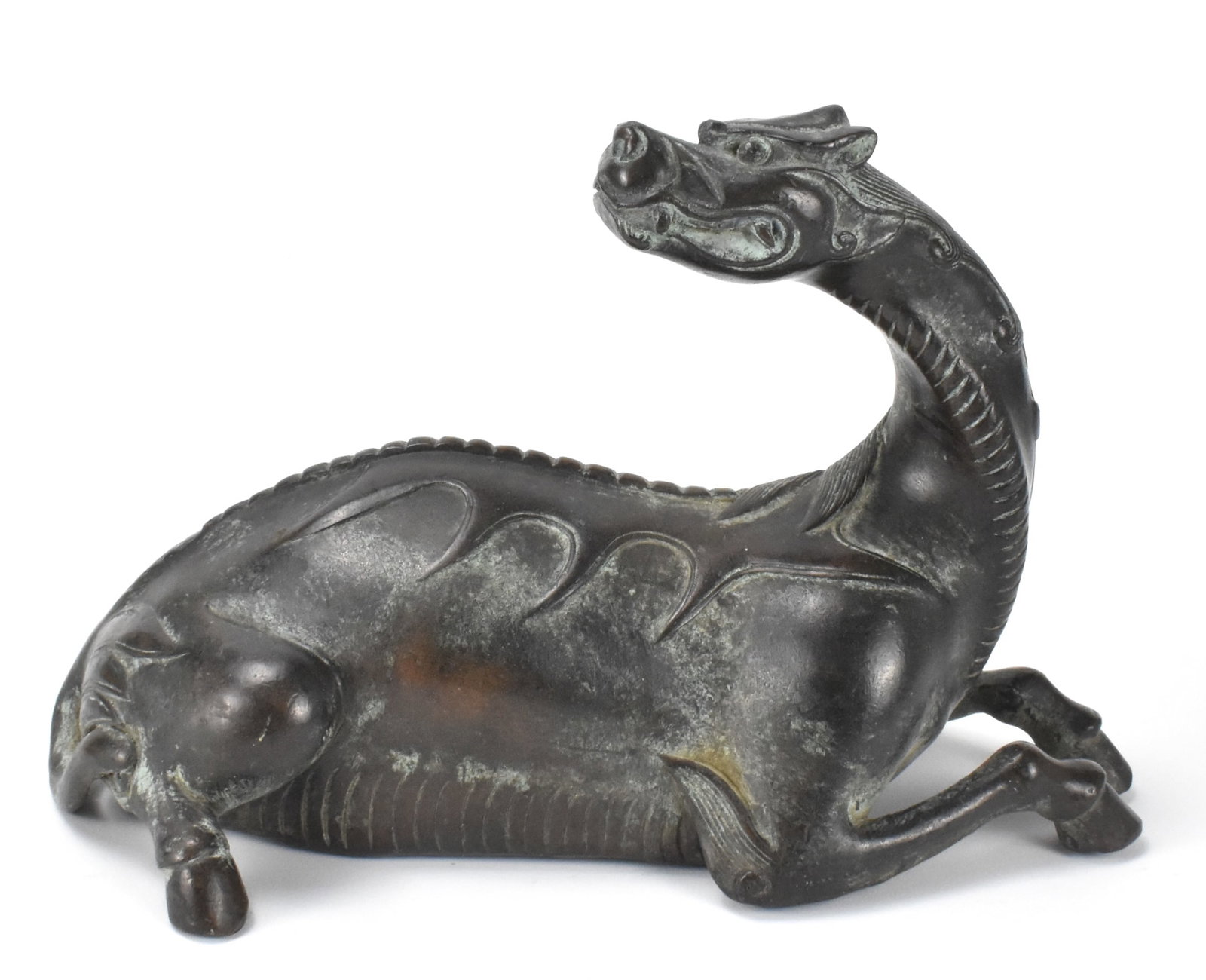 Chinese Bronze Cast Kirin Beast, Ming Dynasty: A Chinese bronze cast Kirin beast, dating from the Ming dynasty (1368-1644). Beast resting on all four legs, two legs in front with detailed hoofs, long dragon neck raised up and turned over body, wit