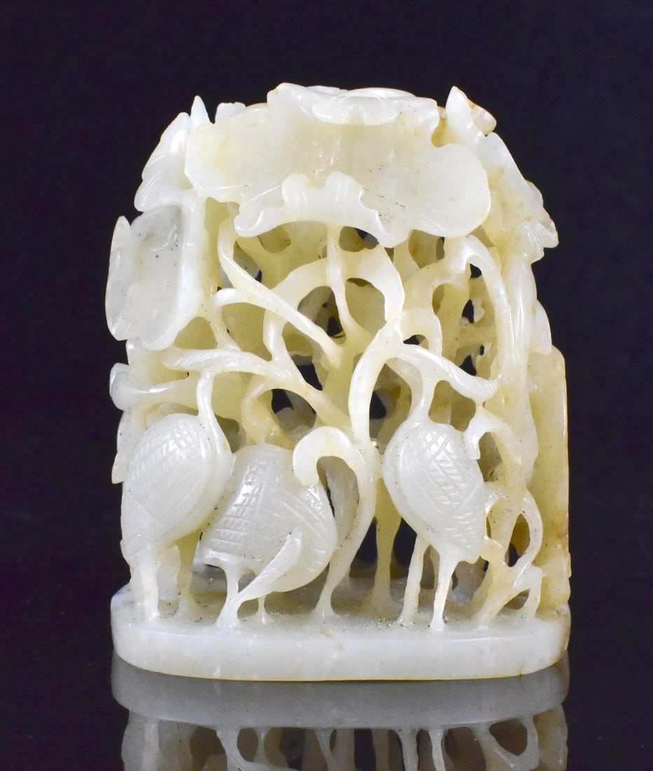 Chinese Jade Carved Finial w/ Stork, Ming Dynasty: A Chinese jade carved finial, dating from the Ming dynasty(1368-1644). A rounded form on a flat oval base is beehive shaped and densely reticulated with detailed scrolling lotus leaves and storks. H. 