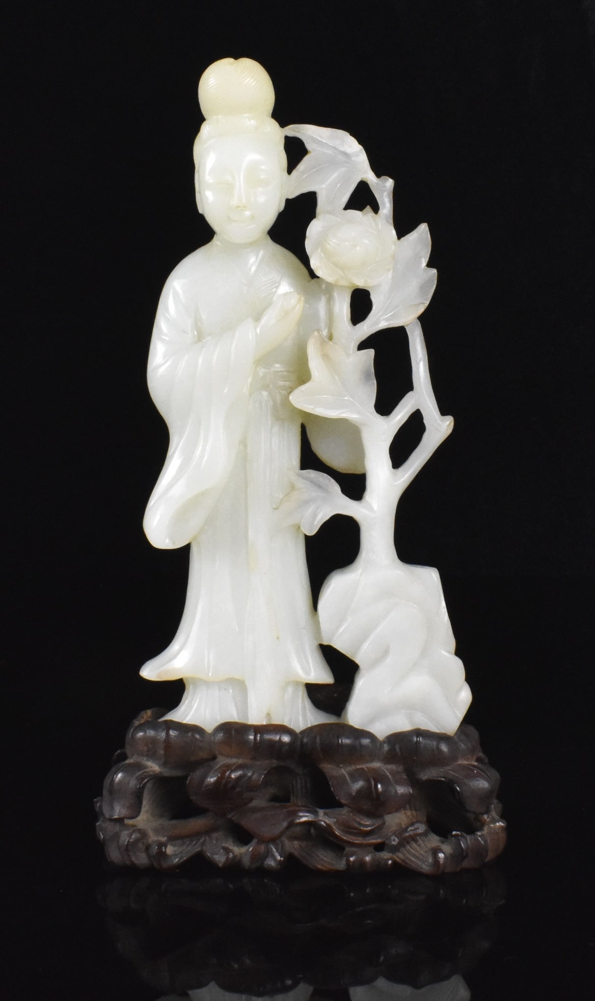 Chinese White Jade Carved Figure on Stand,19th C: Chinese White Jade Carved Figure 19th Century with stand. The female figure stands in her robe with left hand on a tall vertical floral plant which reaches up to her head. Accompanied by a deeply carv